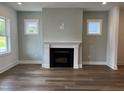 Bright living room with a modern fireplace and elegant hardwood floors at 1903 Plott Balsam Dr, Wendell, NC 27591