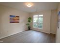 Bedroom featuring a light wood floor, a large window, and neutral-colored walls, creating a bright and inviting atmosphere at 2520 Friedland # 202, Raleigh, NC 27617