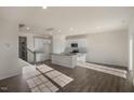 An open concept kitchen featuring modern white cabinets, stainless appliances, and a central island at 2562 Summersby Dr, Mebane, NC 27302