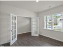 Flex room with hardwood floors, white walls, a window, and glass French doors at 2735 Luxborough Ln, Mebane, NC 27302