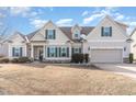 Attractive two-story home featuring beige siding, green shutters, and a well-manicured front yard in a quiet neighborhood at 32 Colson Dr, Garner, NC 27529