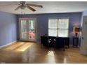 Bright bedroom with natural light, ceiling fan, wood floors, and French doors to the outdoor deck at 3616 Blue Ridge Rd, Raleigh, NC 27612