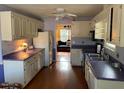 Traditional kitchen with white cabinets, laminate countertops, stainless steel appliances, and hardwood floors at 3616 Blue Ridge Rd, Raleigh, NC 27612