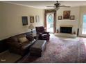 Cozy living room featuring a fireplace, hardwood floors, comfortable seating and access to the patio at 3616 Blue Ridge Rd, Raleigh, NC 27612