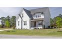 Beautiful two-story home with a covered porch and manicured landscaping at 3913 Berkeley Town Ln, Fuquay Varina, NC 27526