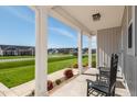 Inviting front porch showcasing two black rocking chairs and neighborhood views at 40 Thunder Valley Ct, Lillington, NC 27546