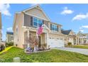 Angle view of the home, emphasizing its well-kept lawn, attached two-car garage, and the adjacent property at 4052 Dunkirk Dr, Burlington, NC 27215
