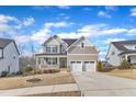Beautiful two-story home with a front porch, stone accents, and a two-car garage at 525 Marion Hills Way, Knightdale, NC 27545
