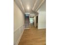 Elegant foyer featuring hardwood floors, wainscoting, and a staircase at 60 Valebrook Ct, Youngsville, NC 27596