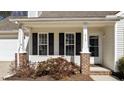 Up close view of the front porch featuring brick column bases and house number at 613 Flaherty Ave, Wake Forest, NC 27587
