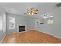 Bright living room featuring hardwood floors, fireplace, and ample natural light at 613 Flaherty Ave, Wake Forest, NC 27587