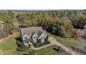 A charming two-story home with a well-manicured lawn and mature trees at 690 Hawthorne Pl, Creedmoor, NC 27522