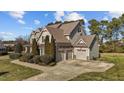 Attractive traditional style home with manicured lawn, mature trees and three-car garage at 690 Hawthorne Pl, Creedmoor, NC 27522