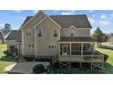 Two-story traditional home featuring a rear screened porch and patio area at 690 Hawthorne Pl, Creedmoor, NC 27522