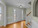 Bright foyer featuring hardwood floors, staircase, and decorative wall trim at 8712 New River Cir, Raleigh, NC 27603