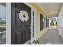Close-up of the front door with a decorative wreath and sidelight windows at 8712 New River Cir, Raleigh, NC 27603