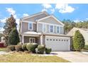 Two-story home showcasing a front-facing two-car garage and a landscaped front yard at 904 Churchill Glen Blvd, Knightdale, NC 27545