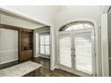 Bright foyer with white trim, hardwood floors, and adjacent room with built-in shelves at 9244 Palm Bay Cir, Raleigh, NC 27617