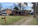 Charming single-story brick house with well-manicured lawn and mature trees at 103 W Thorndale Dr, Oxford, NC 27565