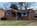 Beautiful single-Gathering home featuring classic brickwork and a manicured lawn at 103 W Thorndale Dr, Oxford, NC 27565