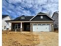 New construction features a brick facade, a two-car garage, and a contrasting gray gable at 1067 Fairhaven Dr # 53, Mebane, NC 27302