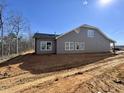 New construction shows a gray vinyl siding and views of a private backyard at 1067 Fairhaven Dr # 53, Mebane, NC 27302