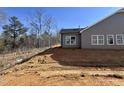 New construction shows a gray vinyl siding and views of a private backyard at 1067 Fairhaven Dr # 53, Mebane, NC 27302
