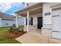 Inviting front porch with brick accents and well-maintained landscaping at 111 E Victory View Ter, Smithfield, NC 27577