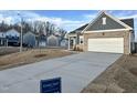 Inviting curb appeal with a well-manicured lawn and a long driveway leading to an attached garage at 1115 Centerview, Nashville, NC 27856