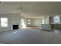 Bright and airy living room featuring a ceiling fan, a fireplace, and multiple windows for plenty of natural light at 12 Flatland Dr, Princeton, NC 27569