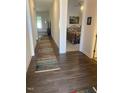 Hallway with wood floors leading to bedroom with carpet at 1216 Blue Mist Ct, Apex, NC 27502