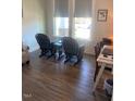 Cozy living room features hardwood floors, large windows, and comfortable seating at 1216 Blue Mist Ct, Apex, NC 27502