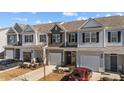 Charming townhome with attached garage, manicured lawn, and inviting curb appeal at 123 Liam St, Clayton, NC 27520