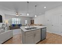 Open kitchen concept with stainless steel dishwasher and center island with a double basin sink at 123 Liam St, Clayton, NC 27520