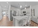 Bright kitchen featuring stainless steel appliances, a center island and barstool seating at 123 Liam St, Clayton, NC 27520