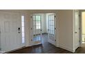 Bright entryway showcasing wood floors, double doors leading to an office, and a front door with sidelight at 124 Willow Cameron Way, Angier, NC 27501