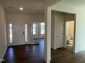 Spacious entryway featuring wood floors, access to a half bathroom, and glass paneled double doors at 124 Willow Cameron Way, Angier, NC 27501