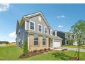 Charming two-story home with brick and siding, landscaped yard, and attached two-car garage at 124 Willow Cameron Way, Angier, NC 27501