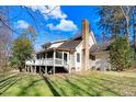Home featuring a screened porch and a spacious deck overlooking the private backyard at 12808 Old Stage Rd, Willow Springs, NC 27592