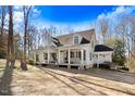 Beautiful two-story home with a spacious front porch, swing, and inviting curb appeal on a wooded lot at 12808 Old Stage Rd, Willow Springs, NC 27592