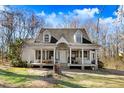 Inviting home with a full, covered front porch, perfect for relaxing and enjoying the outdoors at 12808 Old Stage Rd, Willow Springs, NC 27592