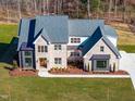 Aerial view of a brick home with an attached garage, set on a large, well-maintained lot at 149 Bonica Creek Dr, Garner, NC 27529
