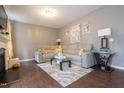 Spacious living room with hardwood floors, comfortable sectional sofa, and elegant decorations at 207 Kinnakeet Dr, Durham, NC 27704