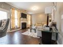 Comfortable living room featuring a fireplace, hardwood floors, modern furniture, and stylish decor at 207 Kinnakeet Dr, Durham, NC 27704