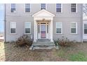 Close-up of the home entrance with a decorative front door and columned portico at 2110 Cokey Rd, Rocky Mount, NC 27801