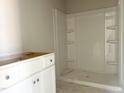 Bathroom featuring a stand-up shower, and an unfinished vanity awaiting its countertop, in a new home at 212 Fast Pitch Ln, Four Oaks, NC 27524