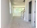Spacious living room with a staircase, large windows and natural light at 212 Fast Pitch Ln, Four Oaks, NC 27524