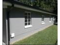 The exterior of this house is painted grey and has large windows with white trim at 216 Clayton St, Rocky Mount, NC 27803