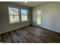 Cozy dining area with wood flooring, abundant natural light, and access to the outdoor space at 24 Heatherglenn Cir, Princeton, NC 27569