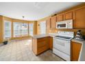 Bright kitchen with breakfast nook, white appliances, and a view of the backyard at 2574 Primrose Ln, Creedmoor, NC 27522